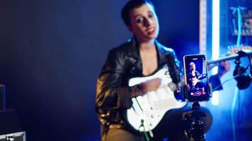 Social media artist live streaming a song for her music vlog, live event vocal performance online on internet. Content creator doing a broadcast for fan engagement, online concert. Camera A. video