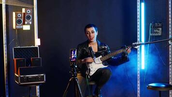 Social media artist live streaming a song for her music vlog, live event vocal performance online on internet. Content creator doing a broadcast for fan engagement, online concert. Camera B. video