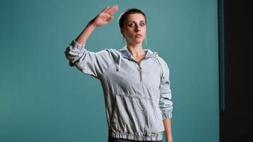 Proud female model showing the military salute with discipline and integrity, showing her patriotism and values. Stylish attractive woman symbolizing respect for soldiers and for the army. Camera A. video
