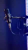 Vertical Modern recording microphone on stage in the studio used to create rock or pop music, live creative performance before a concert. Empty space with electronics for live music and production. video