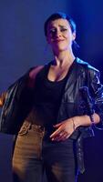 Vertical Musical talent vocalist showing the mute symbol to be silent, emphasizing empowerment and no hate. Rock star woman doing a hush sign for a cultural statement, rebellious attitude. Camera A. video