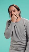 Vertical Portrait of cheerful man laughing hard, amused by funny joke, studio background. Happy Arab person chuckling and giggling, delighted by comedy, feeling entertained, camera B video