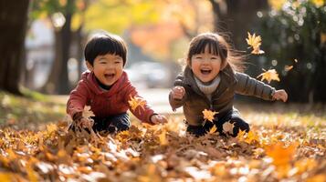 Two Children Laughing and Playing in a Pile of Autumn Leaves photo