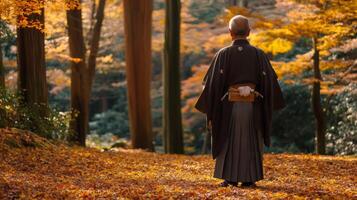 Man in Traditional Japanese Clothing Amidst Autumn Foliage photo