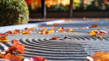 Autumn Leaves Scattered on a Circular Pattern in a Zen Garden photo