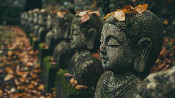 Stone Statues with Autumn Leaves in a Forest Setting photo