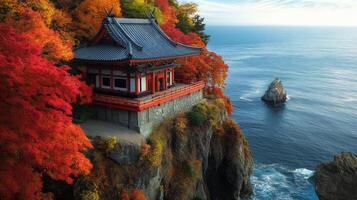 Japanese Temple Perched on Cliff Overlooking the Ocean in Autumn photo