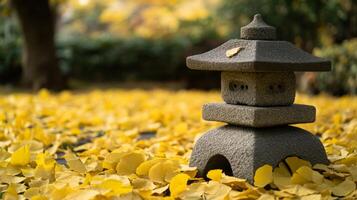 Stone Lantern Amidst a Carpet of Golden Ginkgo Leaves photo