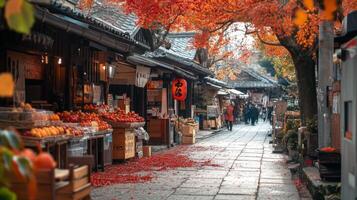 Narrow Japanese Street Lined with Shops and Covered in Fallen Maple Leaves photo