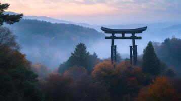 Traditional Japanese Torii Gate in Misty Mountain Forest at Dawn photo