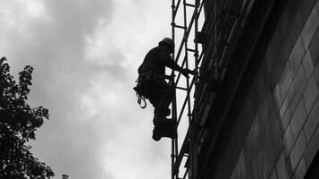 Silhouetted Worker on Scaffolding Against a Cloudy Sky photo