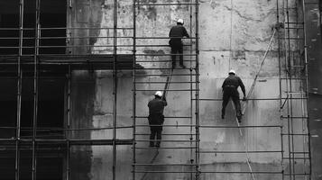 Three Construction Workers on Scaffolding Against a Weathered Wall photo