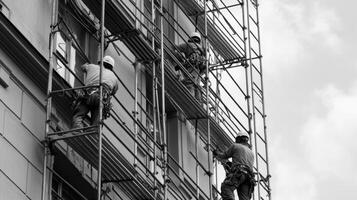 Construction Workers on Scaffolding Repairing Building Facade photo