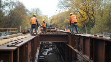 Construction Workers Installing Steel Beams on a Bridge photo