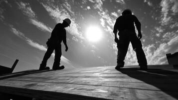 Two Construction Workers Silhouetted Against a Cloudy Sky photo