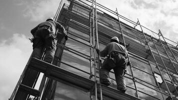 Two Construction Workers on Scaffolding During Building Renovation photo