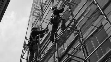 Two Construction Workers on Scaffolding Working on a Building photo