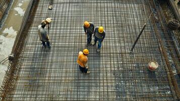 Construction Workers Inspecting Steel Reinforcement Mesh photo