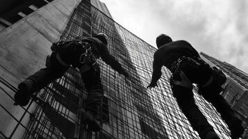 Two Workers Ascending a Concrete Building with Safety Nets photo