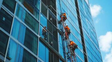 Workers Cleaning Windows on a Modern Glass Building photo