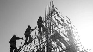 Construction Workers Ascending Scaffolding on a Building Site photo