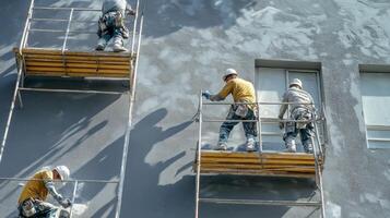 Construction Workers Applying Stucco to a Building photo