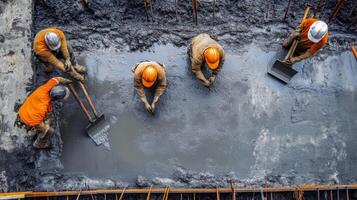 Construction Workers Leveling Wet Concrete with Tools photo