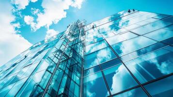 Glass Facade of a Modern Building Reflecting Clouds and Sky photo