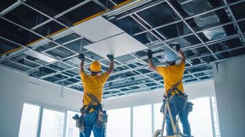 Two Construction Workers Installing a Drywall Ceiling photo