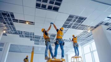 Construction Workers Installing Ceiling Tiles photo