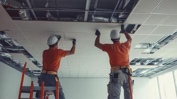 Two Construction Workers Installing a Ceiling photo