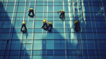 Window Washers Cleaning a Tall Modern Glass Building photo