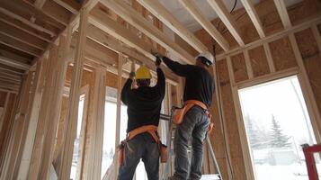 Two Construction Workers Installing a Window Frame photo