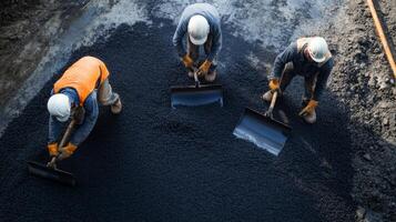 Construction Workers Spreading Asphalt With Shovels photo