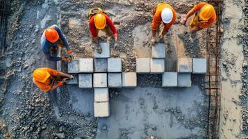 Construction Workers Placing Concrete Blocks on a Foundation photo