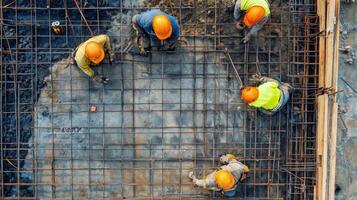 Construction Workers Assembling a Steel Grid for Concrete Pouring photo