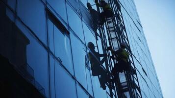 Workers Cleaning the Windows of a Modern Building photo