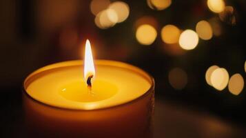 A Lit Candle with a Blurred Background of Bokeh Lights photo