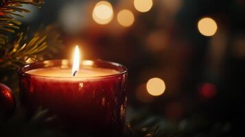 A Lit Candle with a Blurred Festive Background photo