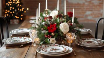 Christmas Table Setting with White Roses, Poinsettia, and Candles photo