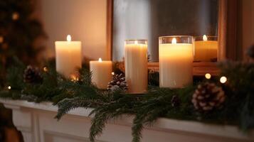 Burning Candles with Pine Branches on a White Mantel photo