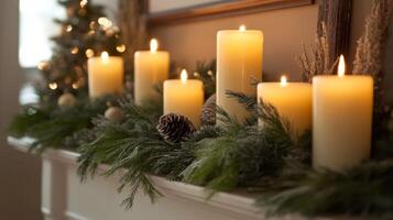 Burning Candles Adorned with Evergreen Branches and Pine Cones photo