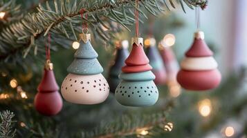 Hand-Painted Christmas Ornaments in the Shape of a Tree Hanging on a Christmas Tree photo