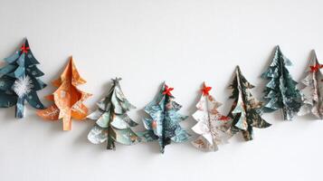 Row of Paper Christmas Trees with Red Bows on White Background photo