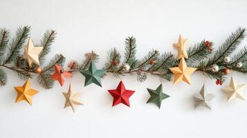 Festive Paper Star Ornaments Hanging From Pine Branch photo