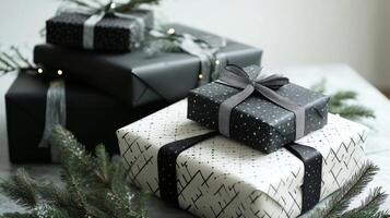 Stack of Stylishly Wrapped Black and White Gifts with Pine Branches photo