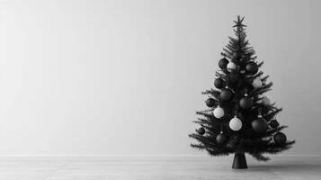Black Christmas Tree with White and Black Ornaments in a Minimalist Room photo