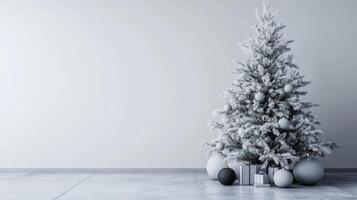 Snowy Christmas Tree with Grey and Black Ornaments and Wrapped Gifts photo