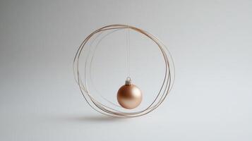 A Golden Ornament Hanging Within a Circular Wire Frame photo