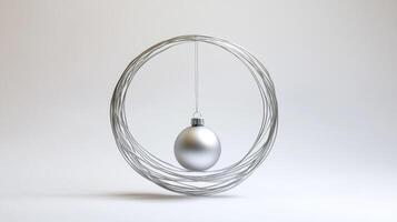 A silver Christmas ornament suspended within a silver wire circle photo